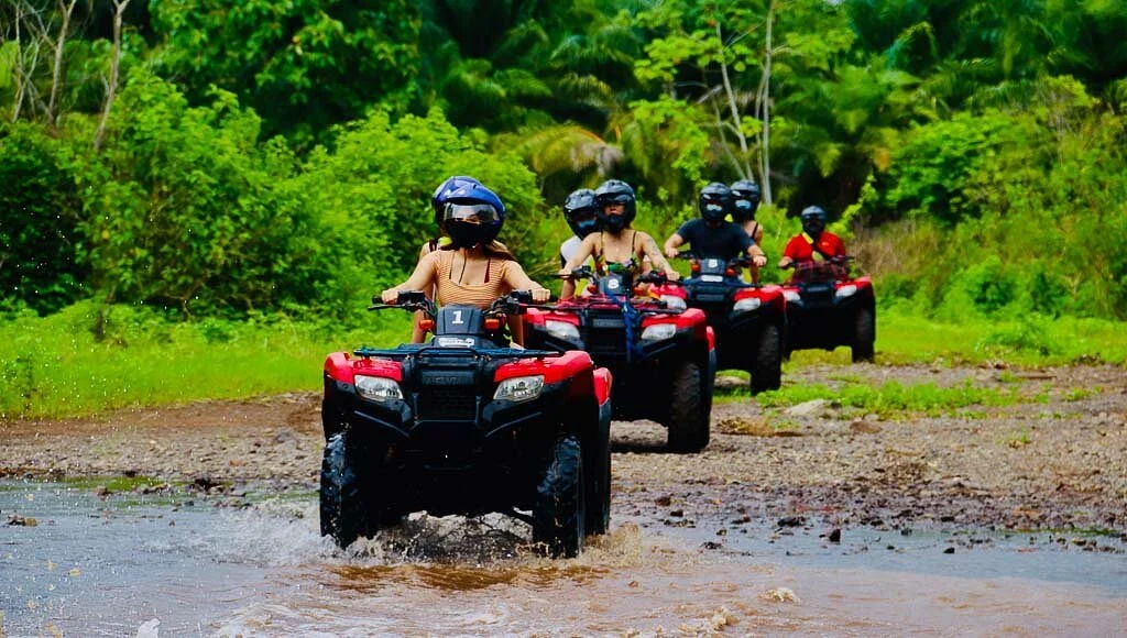 Travelers enjoying a Nassau island tour with ATV buggy and scooter rentals in Nassau Bahamas near beautiful tropical beaches